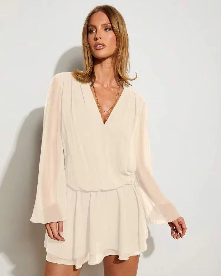 woman in a cream long sleeve wrap mini dress